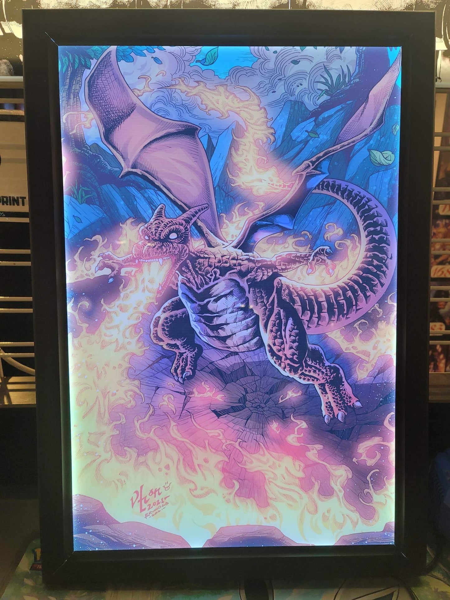 Charizard Pokémon artwork displayed in RGB LED acrylic lightbox frame with fiery glow, perfect for collectors and gaming room displays, Snapping Turtle Gallery.
