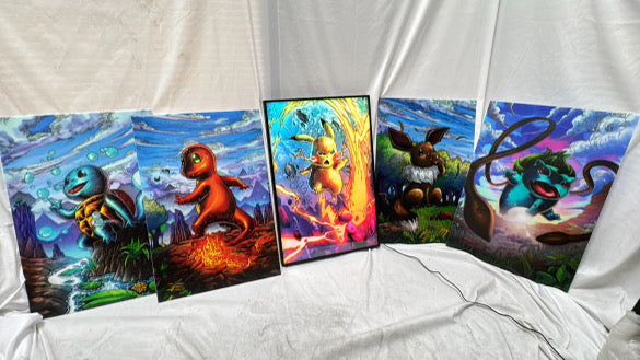 A slim frame RGB LED lightbox displaying vibrant Pokémon artwork illuminated in the center, surrounded by additional artwork panels, showcasing bright, even lighting for collectors, Snapping Turtle Gallery.