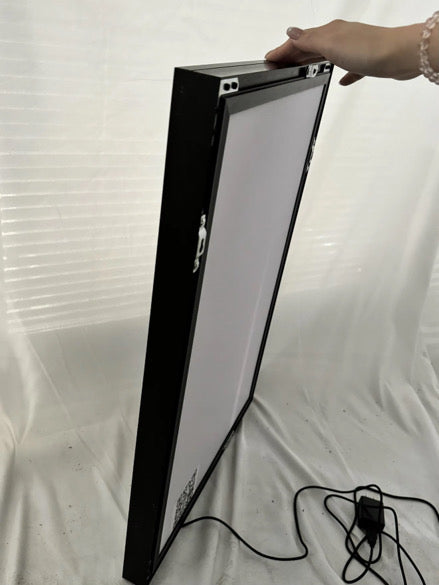 Side view of slim frame RGB LED acrylic lightbox being held to show its ultra-thin profile and lightweight design, perfect for art display, Snapping Turtle Gallery.