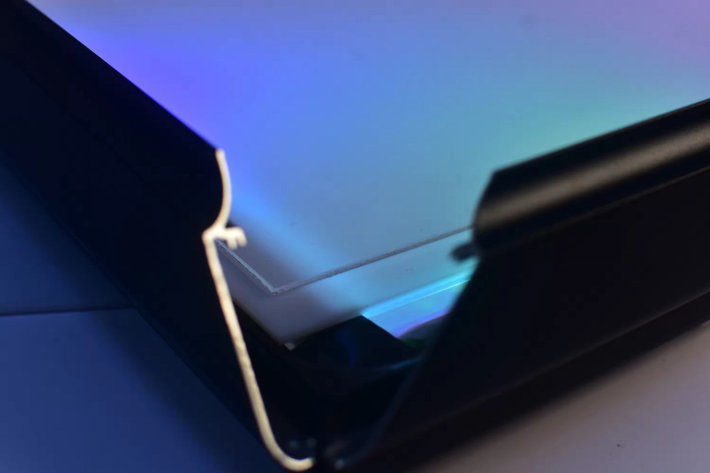 Close-up of the 4-sided snap-close hinge system with RGB LED edge lighting for easy artwork swaps, Snapping Turtle Gallery.
