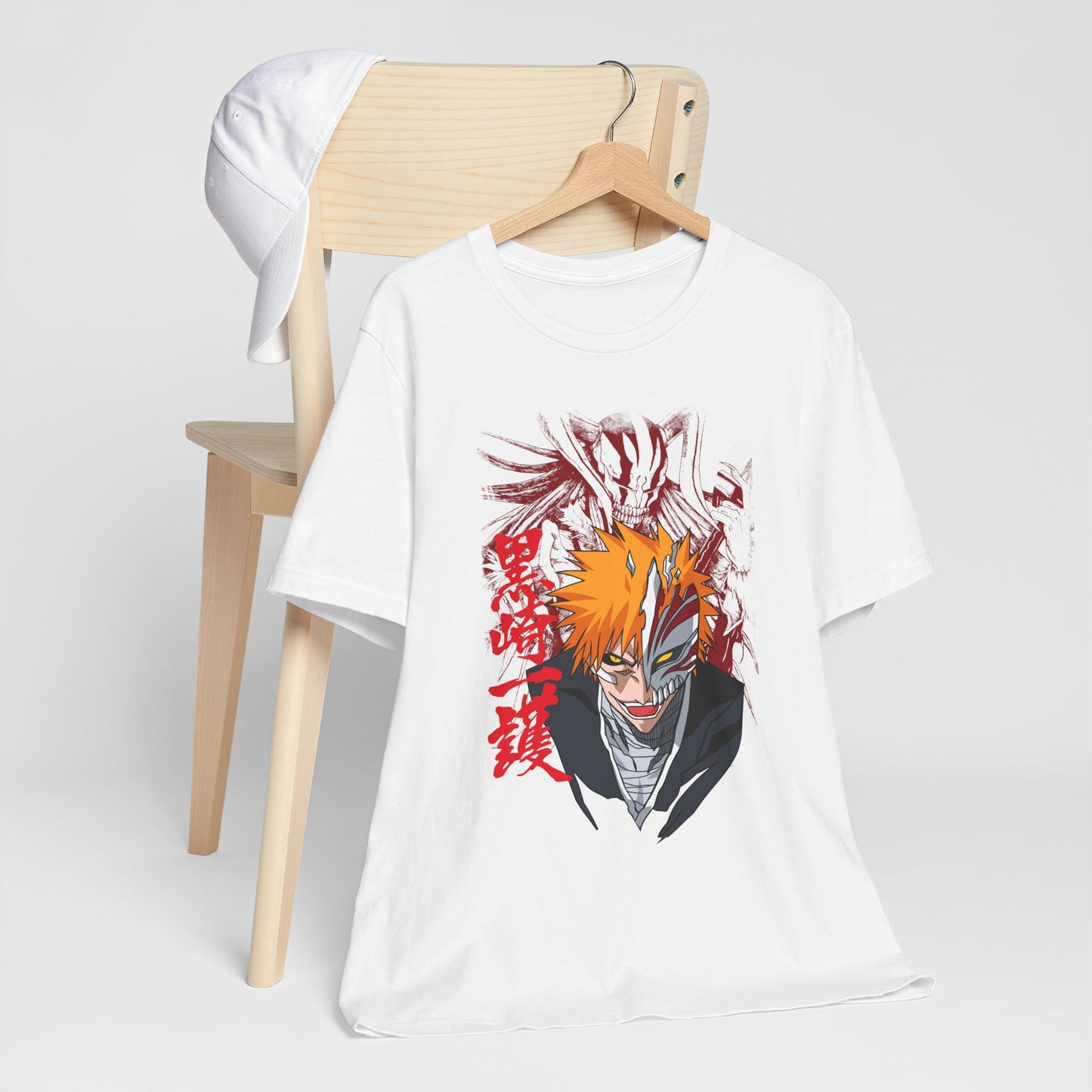 Alt: Hollow Mask Hero Anime Shirt on white, hanging on chair with cap, lifestyle display by Snapping Turtle Gallery