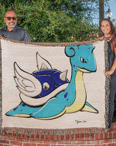 Cozy throw blanket draped over a couch featuring vibrant fan-art design from Snapping Turtle Gallery’s Throw Blanket Artwork Collection.