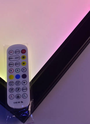 Remote control beside a 16x24 RGB LED acrylic lightbox frame