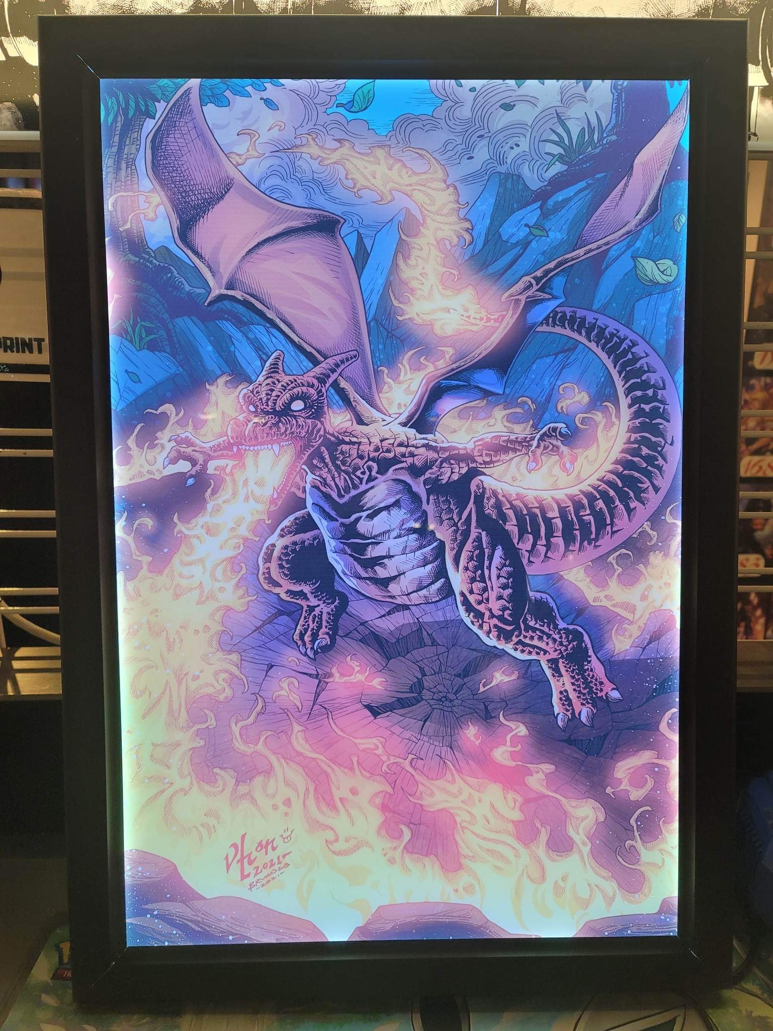 Charizard Pokémon artwork displayed in RGB LED acrylic lightbox frame with fiery glow, perfect for collectors and gaming room displays, Snapping Turtle Gallery.