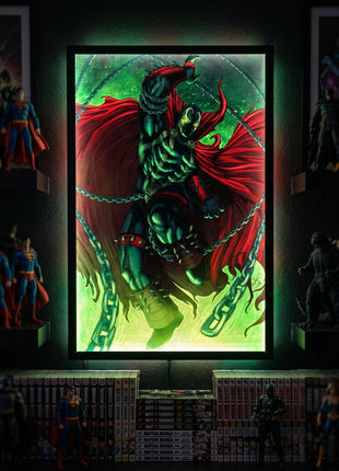 Spawn Chains of Vengeance wall art in an illuminated frame surrounded by comic collectibles, display mockup