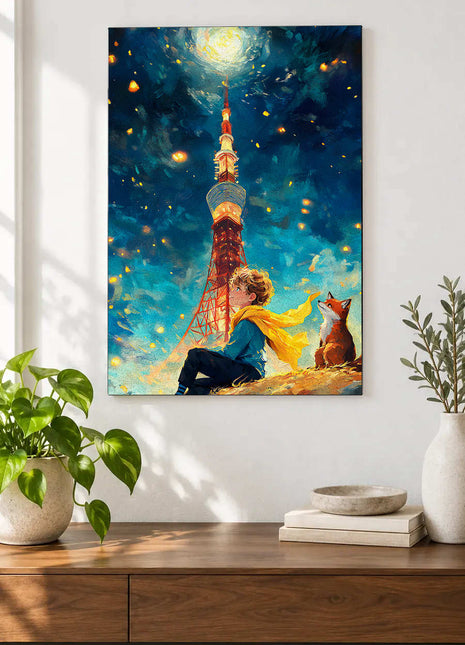 Little Prince and fox on a sloping ridge below a moonlit tower and yellow scarf displayed above a console table in a room setting