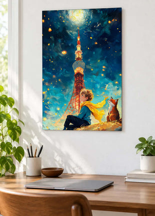 Little Prince and fox on a sloping ridge below a moonlit tower and yellow scarf displayed above a desk in a room setting