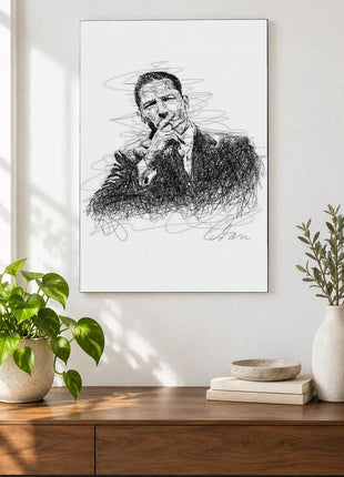 A Pause in Black Ink acrylic wall art displayed above a wooden console with plants and books against a white wall.