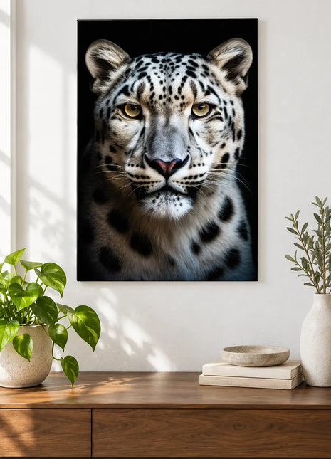 Snow leopard artwork "Soft Spots" shown as a frameless acrylic print above a walnut console against a white wall.