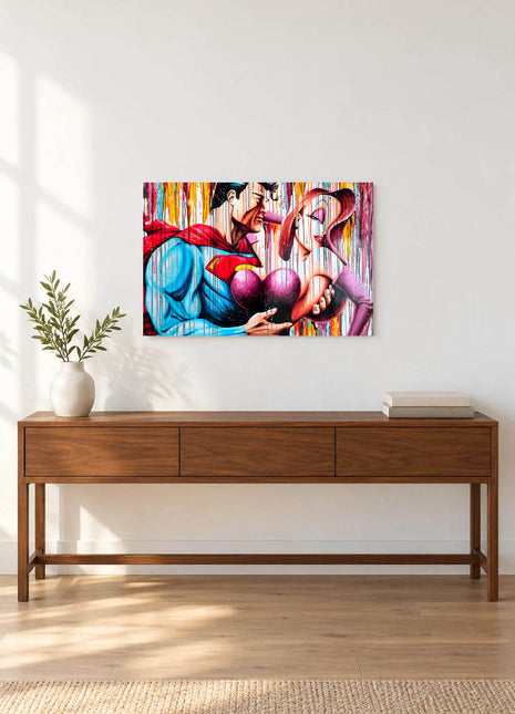 Superman embracing Jessica Rabbit against multicolor paint drips displayed above a console table in a room setting
