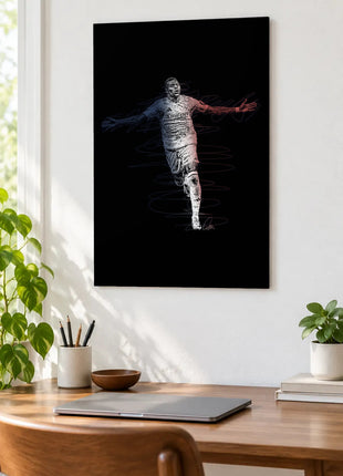 Arms Wide in Split Light acrylic wall art displayed above a wooden desk with a laptop, plants and books against a white wall.