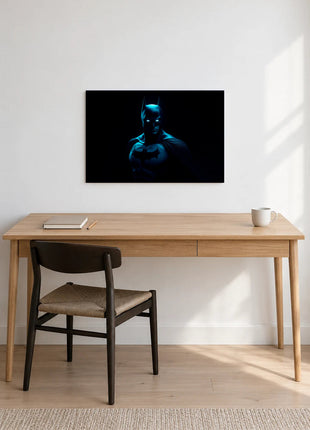 Batman Blue Hour Watch acrylic wall art displayed above a wooden desk with a notebook, pencil and white mug against a white wall.