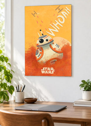 BB-8 Whoa There acrylic wall art displayed above a wooden desk with a laptop, plants and books against a white wall.