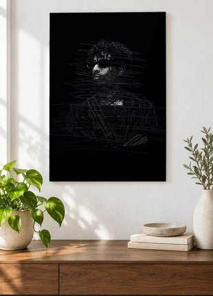 Behind the Dark Lenses acrylic wall art displayed above a wooden console with plants and books against a white wall.