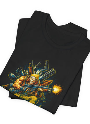 Folded black commando T-shirt showing the blond headbanded figure, ammunition belts, weapons and gold muzzle flash.