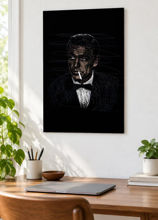 Bow Tie and a Sideways Glance acrylic wall art displayed above a wooden desk with a laptop, plants and books against a white wall.