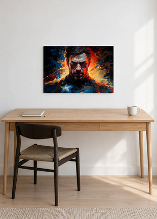 Captain America Unbroken Resolve acrylic wall art displayed above a wooden desk with a notebook, pencil and white mug against a white wall.