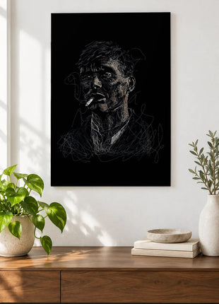 Cigarette in Charcoal Lines acrylic wall art displayed above a wooden console with plants and books against a white wall.