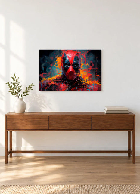 Deadpool Paintstorm Stare acrylic wall art displayed above a wooden console with a leafy vase and stacked books against a white wall.