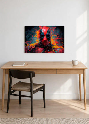 Deadpool Paintstorm Stare acrylic wall art displayed above a wooden desk with a notebook, pencil and white mug against a white wall.