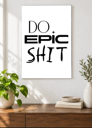 Do Epic Shit acrylic wall art displayed above a wooden console with plants and books against a white wall.