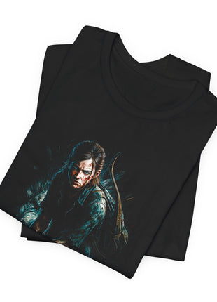 Folded black T-shirt close-up showing Ellie’s face, blue-green shirt and curved bow rising behind her shoulder.