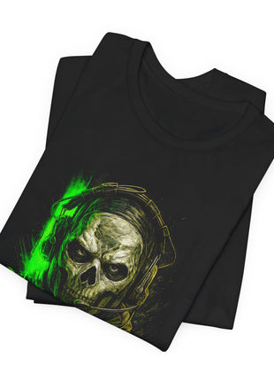 Folded black T-shirt detail showing Ghost’s skull mask, dark eye openings, headset and green accent.