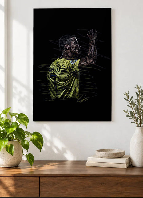 Green Shirt Raised Fist acrylic wall art displayed above a wooden console with plants and books against a white wall.