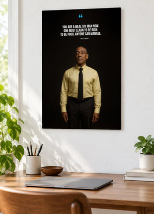 Gus Fring Learning to Be Rich acrylic wall art displayed above a wooden desk with a laptop, plants and books against a white wall.