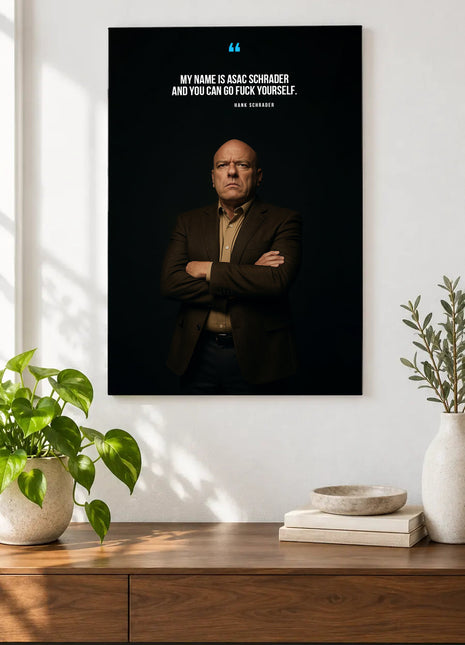 Hank Schrader Final Defiance acrylic wall art displayed above a wooden console with plants and books against a white wall.