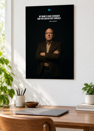 Hank Schrader Final Defiance acrylic wall art displayed above a wooden desk with a laptop, plants and books against a white wall.