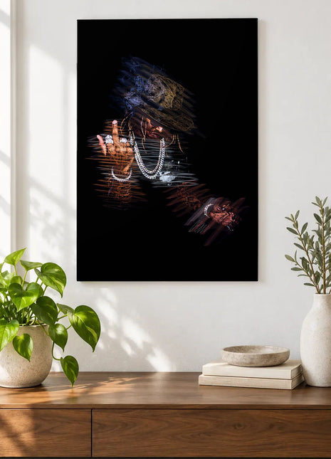 Hat Low, Defiance High acrylic wall art displayed above a wooden console with plants and books against a white wall.