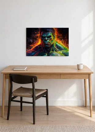 Hulk Rage in Color acrylic wall art displayed above a wooden desk with a notebook, pencil and white mug against a white wall.