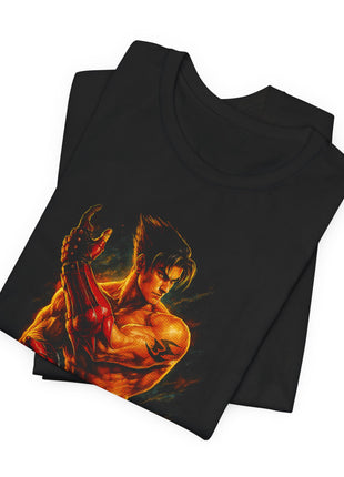 Folded black T-shirt detail showing Jin Kazama’s dark hair, raised red gauntlet and upper-arm marking.