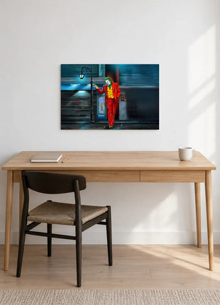 Joker A Light on the Corner acrylic wall art displayed above a wooden desk with a notebook, pencil and white mug against a white wall.