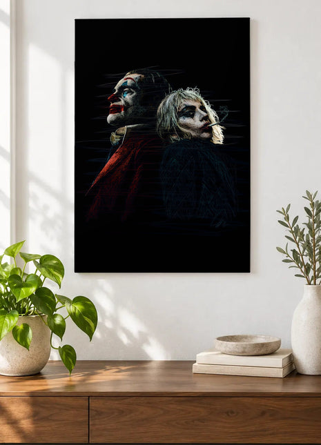 Joker and Harley Back to Back acrylic wall art displayed above a wooden console with plants and books against a white wall.