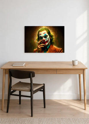 Joker The Last Drag acrylic wall art displayed above a wooden desk with a notebook, pencil and white mug against a white wall.