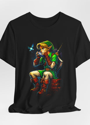 Gathered black T-shirt front displaying seated Link with an ocarina, sword, shield and small blue fairy.