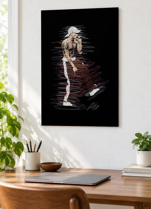 Microphone in Mid-Stride acrylic wall art displayed above a wooden desk with a laptop, plants and books against a white wall.