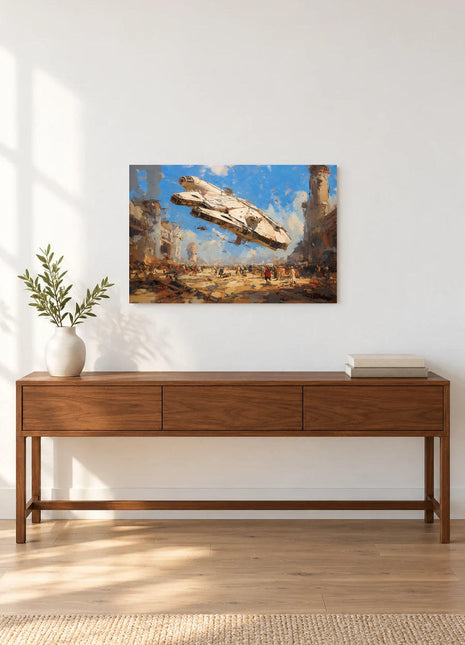 Millennium Falcon Dustbound Arrival acrylic wall art displayed above a wooden console with a leafy vase and stacked books against a white wall.