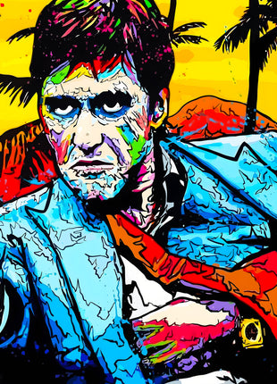 Tony Montana aiming a handgun in a blue jacket against bright palms and yellow sky