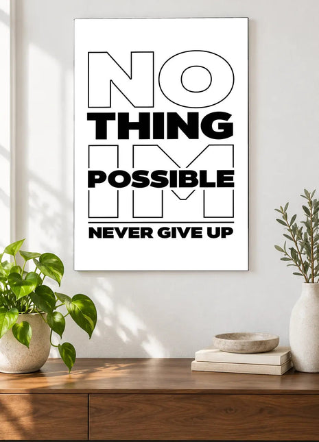 Never Give Up Layered Type acrylic wall art displayed above a wooden console with plants and books against a white wall.