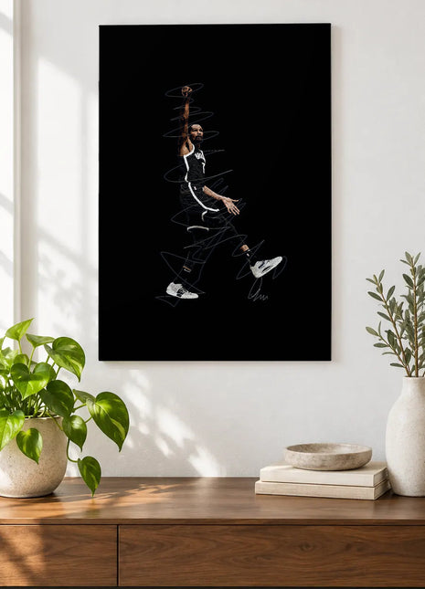 One Arm Above the Game acrylic wall art displayed above a wooden console with plants and books against a white wall.