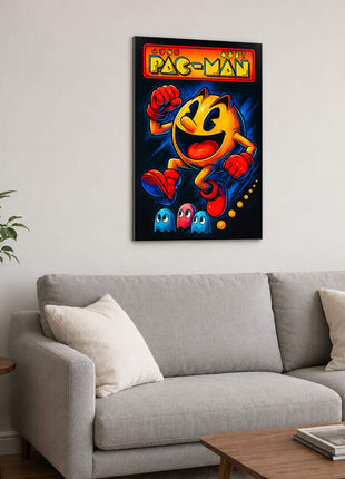 Pac-Man wearing red gloves and boots above three small ghosts, with arcade lettering across the top on metal wall art above a light gray sofa in a living room with white walls.