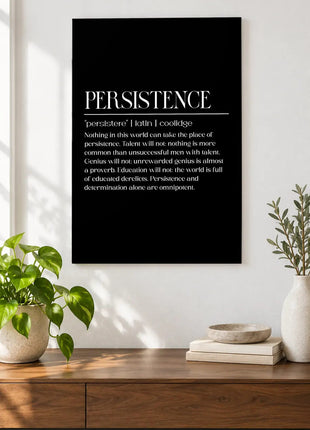 Persistence Holds the Line acrylic wall art displayed above a wooden console with plants and books against a white wall.
