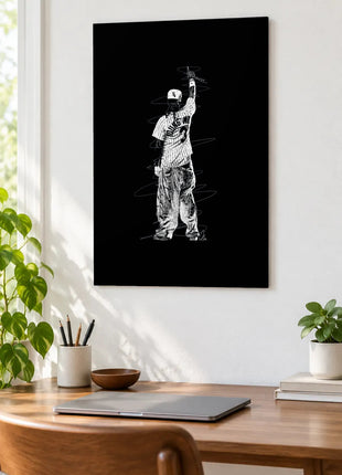 Pinstripes and a Raised Microphone acrylic wall art displayed above a wooden desk with a laptop, plants and books against a white wall.
