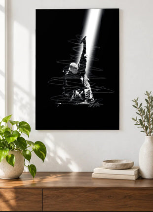 Reaching Through the Spotlight acrylic wall art displayed above a wooden console with plants and books against a white wall.