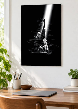 Reaching Through the Spotlight acrylic wall art displayed above a wooden desk with a laptop, plants and books against a white wall.