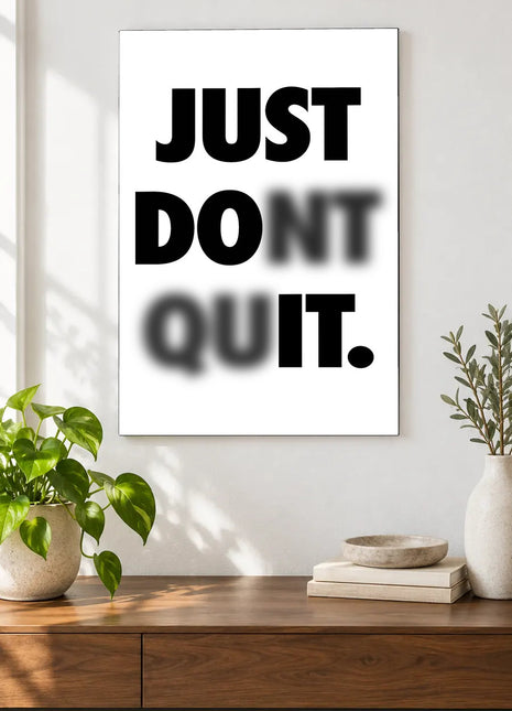 Read Through the Doubt acrylic wall art displayed above a wooden console with plants and books against a white wall.