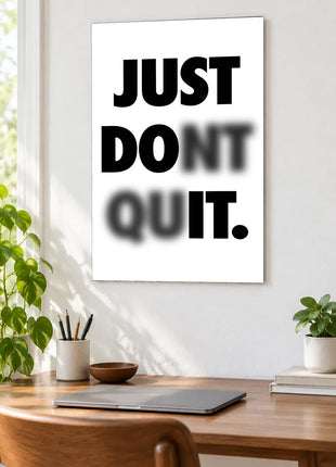 Read Through the Doubt acrylic wall art displayed above a wooden desk with a laptop, plants and books against a white wall.